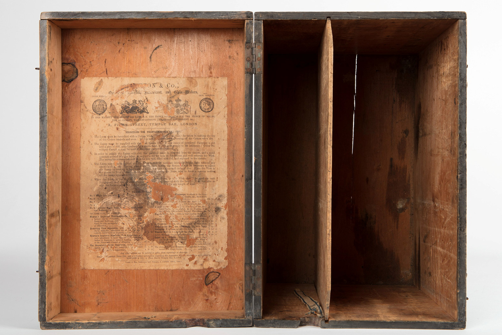View inside timber case with paper notice pasted inside lid.