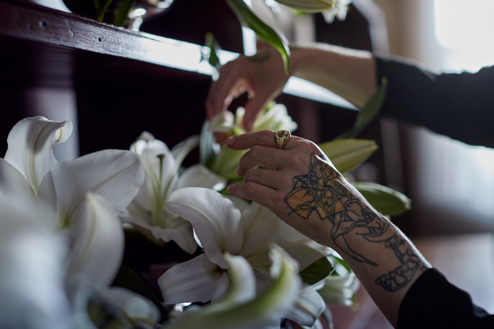 A close up of Lillies in the buffet and Doctor Cooper's hands in the Vaucluse House kitchen as part of her work 'CHURCH FLOWERS AFTER THE BUTCHER, THE BONER; IN THE KITCHEN, THE LARDER' by Doctor Lisa Cooper