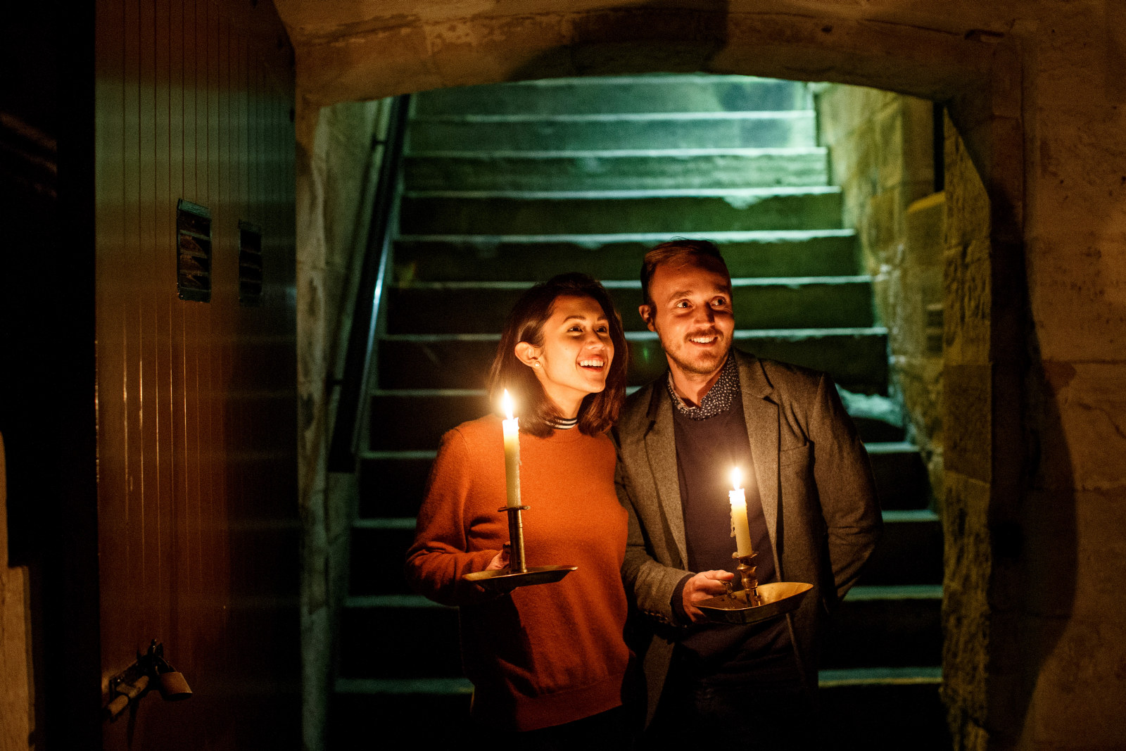 Paul Bennetts and Julie McTernan entering the Cellar holding candles at Elizabeth Bay House