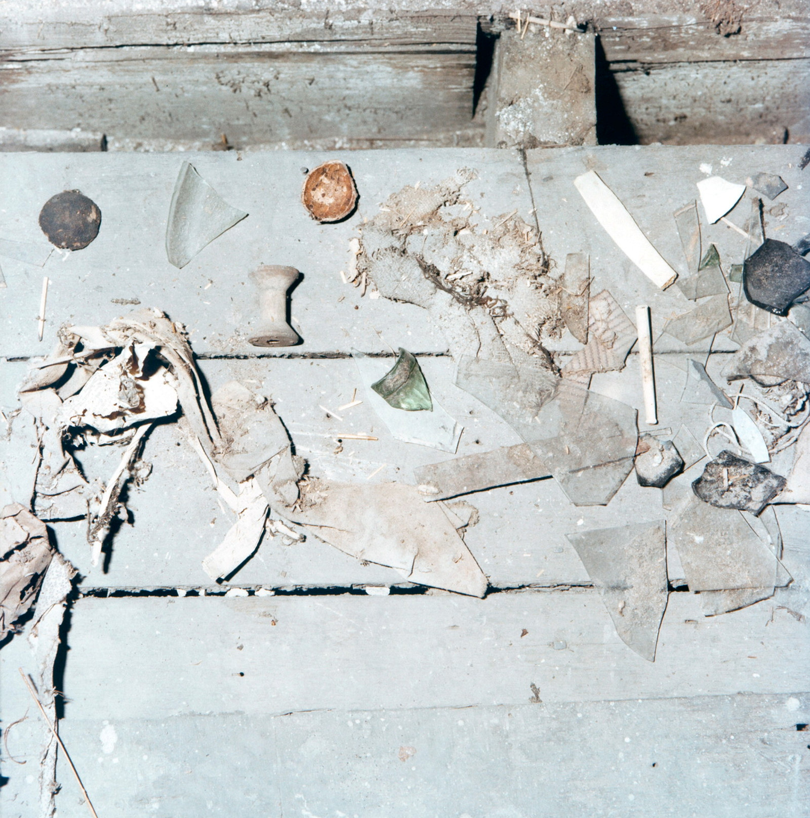Collection of items on floorboards.
