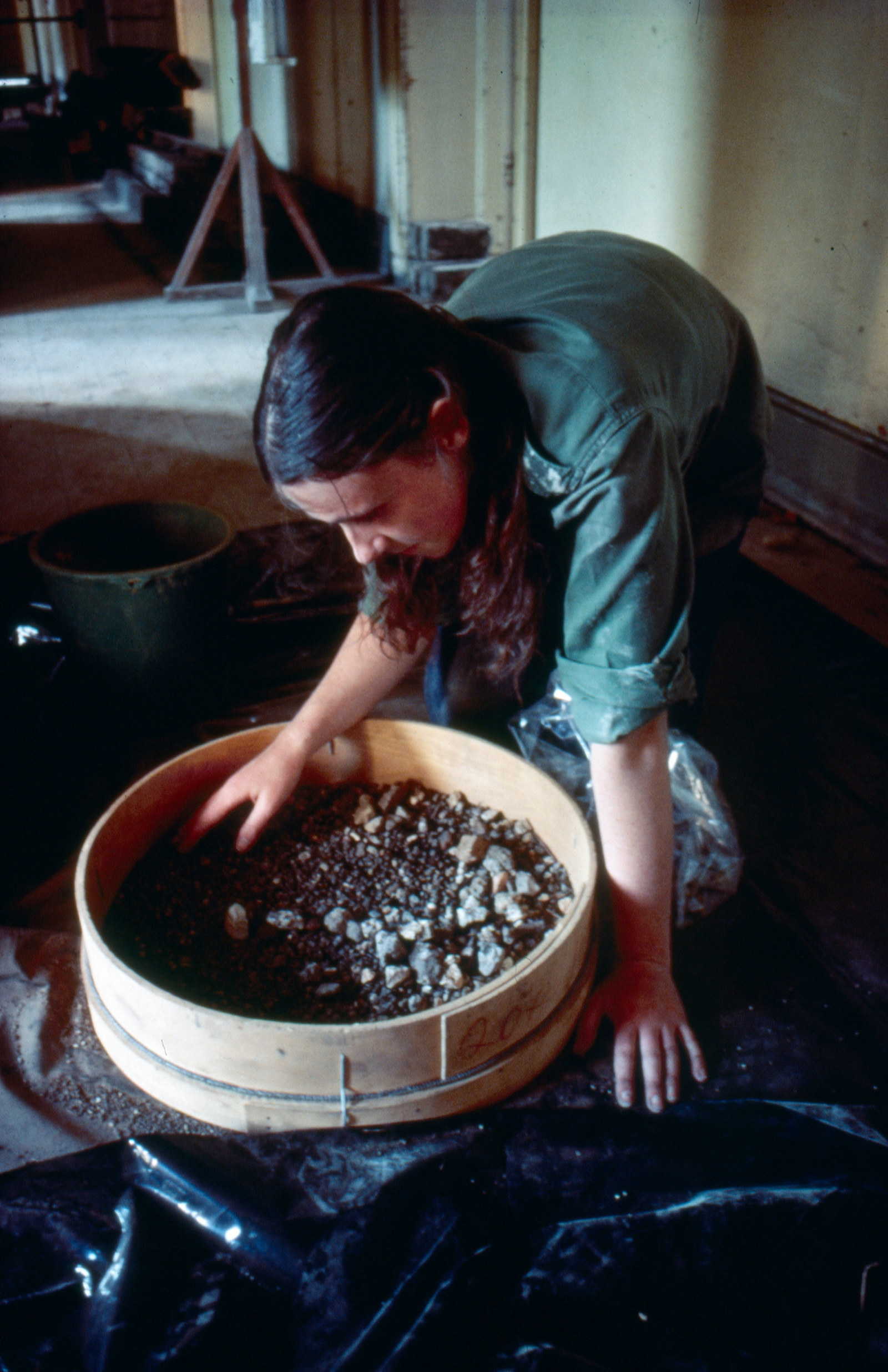 Archaeologist Wendy Thorp looking for small finds after sieving, Hyde Park Barracks, 1981. 