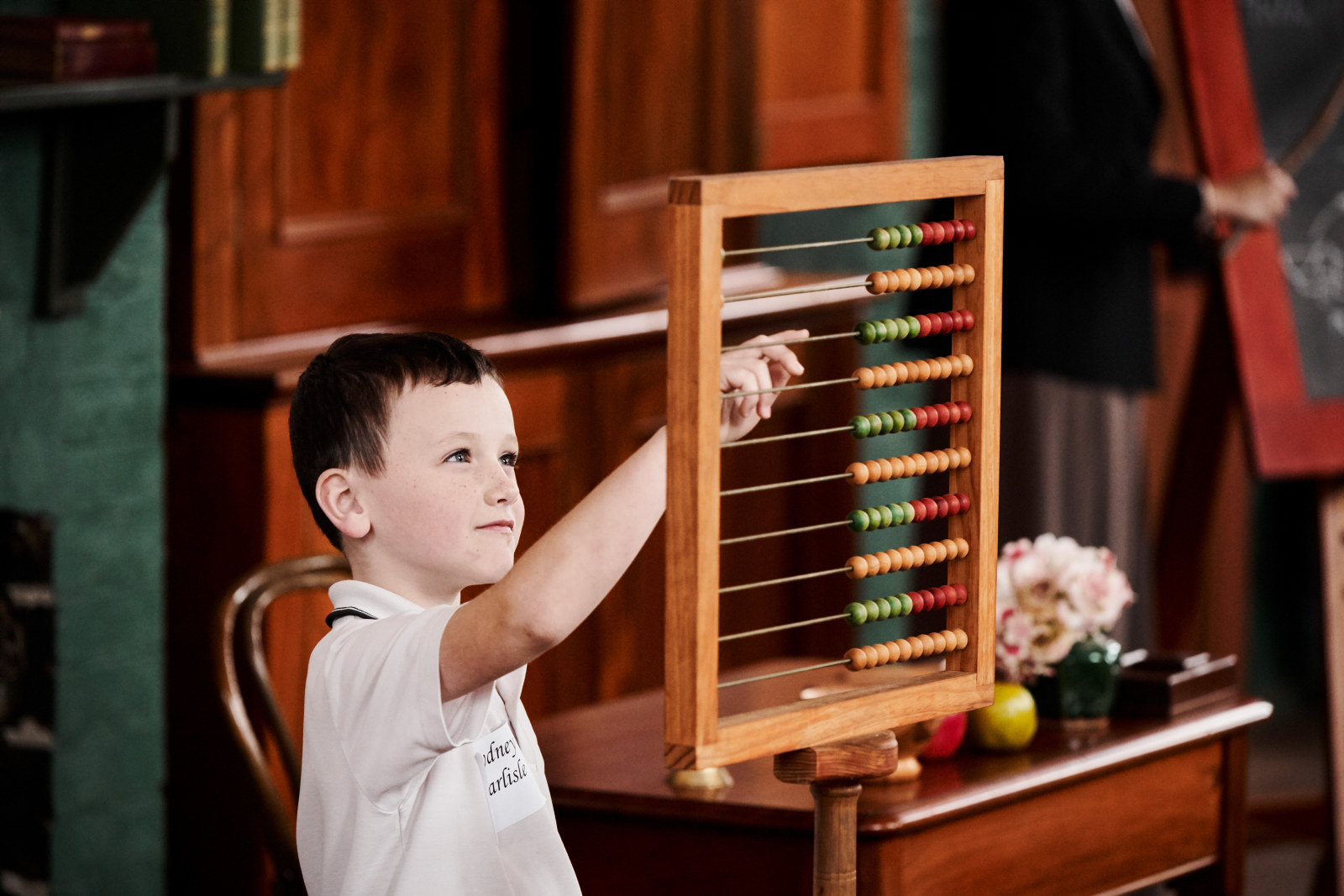 A student using an abacus during a maths lesson as part of Lessons from the Past at Rouse Hill Estate