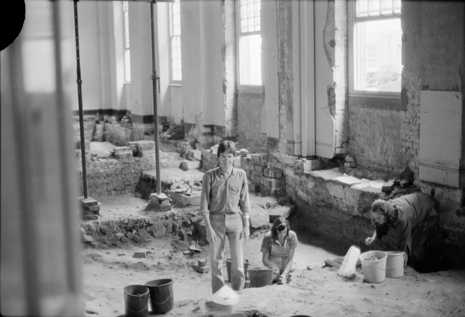Archaeologist Robert Varman and two volunteers excavating the north-east room of the ground floor of Hyde Park Barracks, 1981.