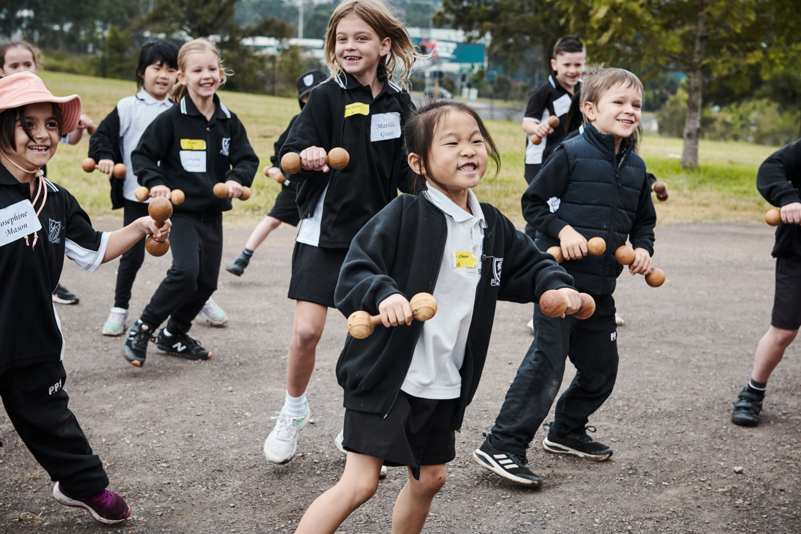 Calisthenics with wooden dumbbells being performed by students as part of Lessons from the Past at Rouse Hill Estate