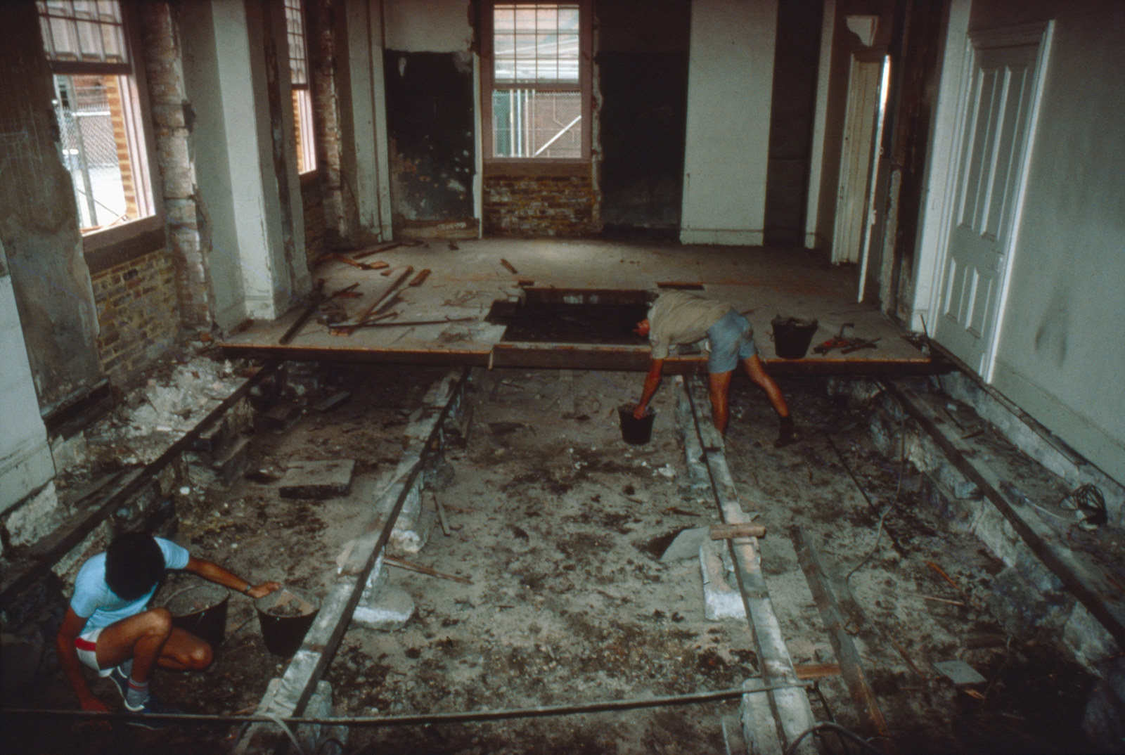 Removing the floorboards from the north-east ground floor room of Hyde Park Barracks, prior to excavation, 1980. 