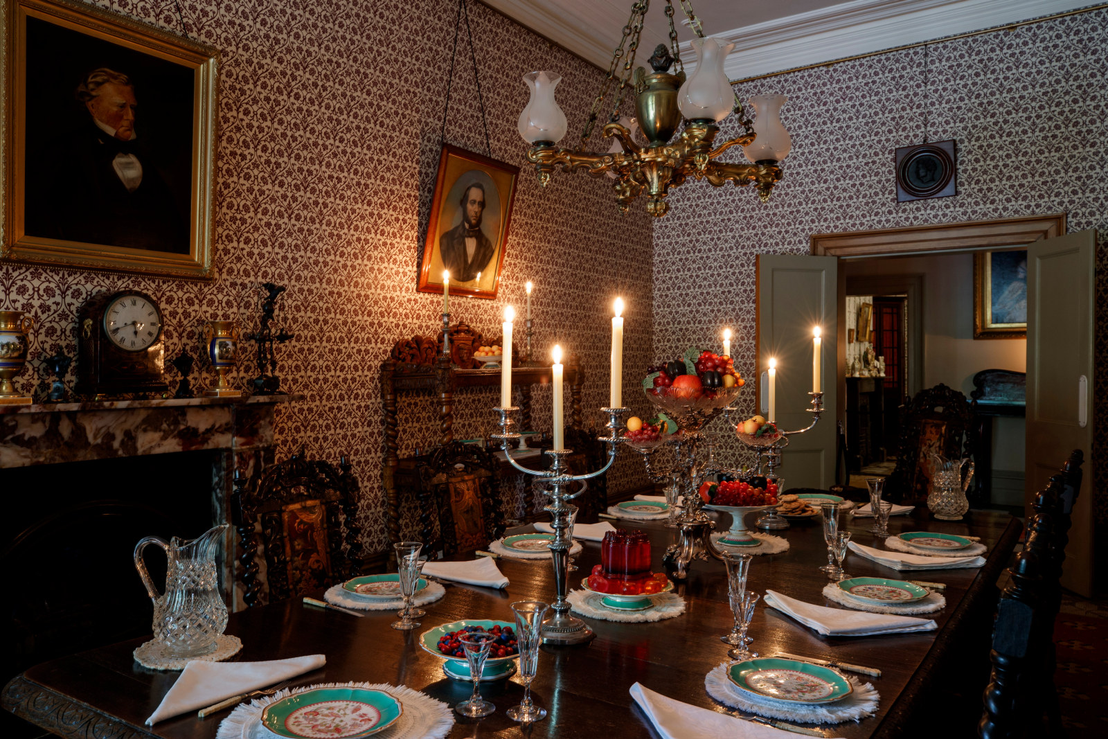 The Vaucluse House dining room fully set and lit by candlelight