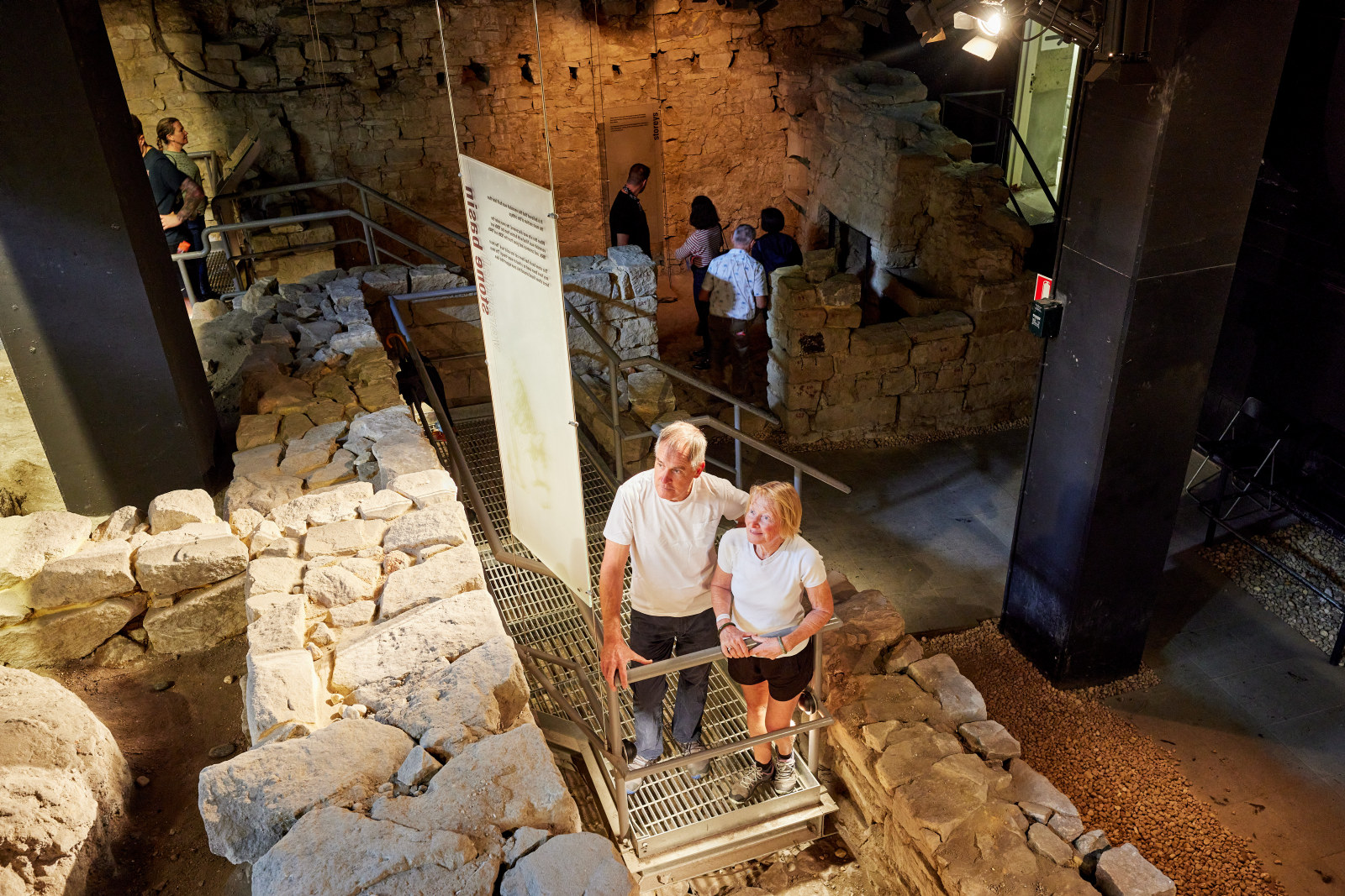 Wide shot of two visitors reading interpretation at Parbury Ruins during Sydney Open
