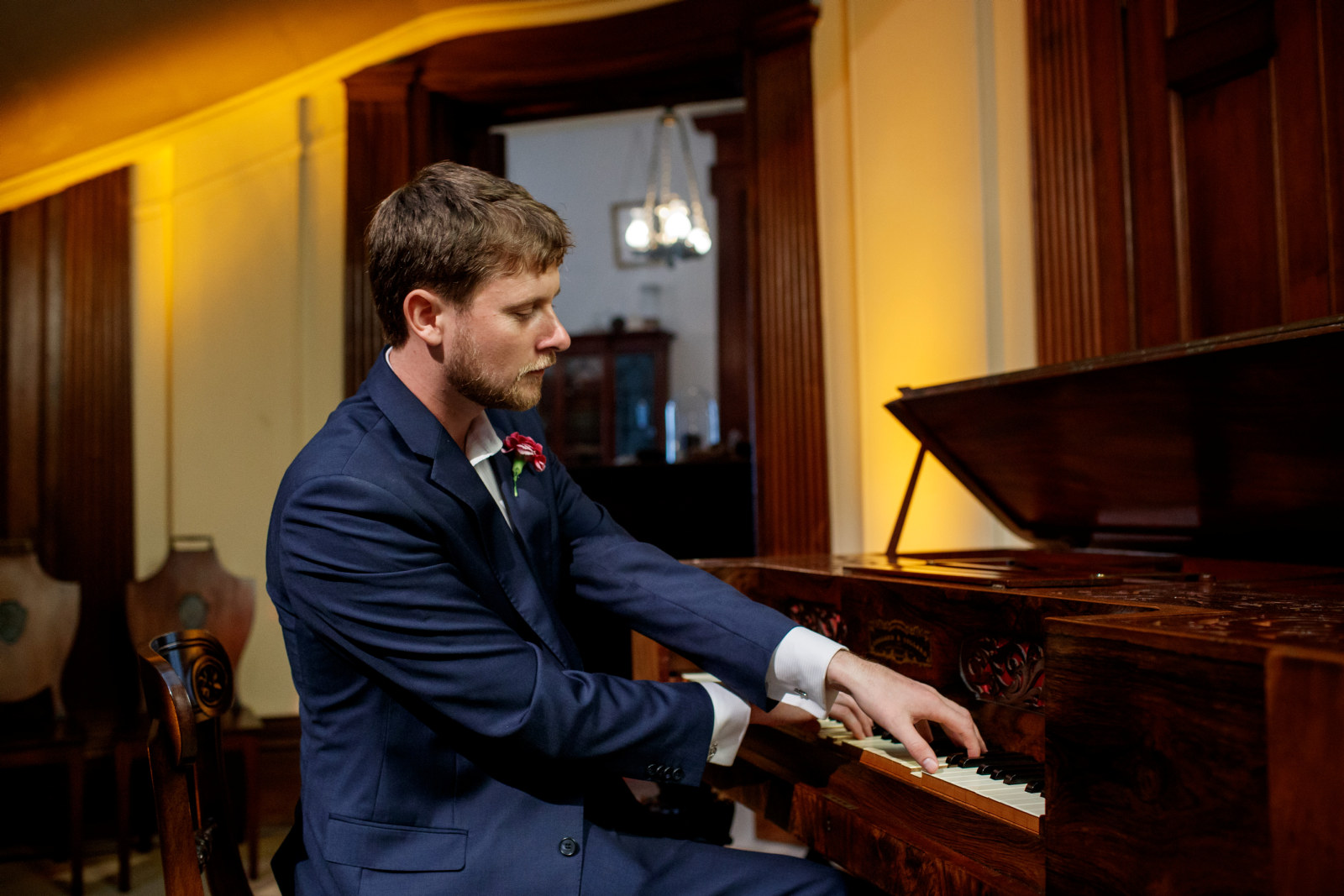 James Doig, postgraduate student, Sydney Conservatorium of Music, playing piano in the saloon at Elizabeth Bay House