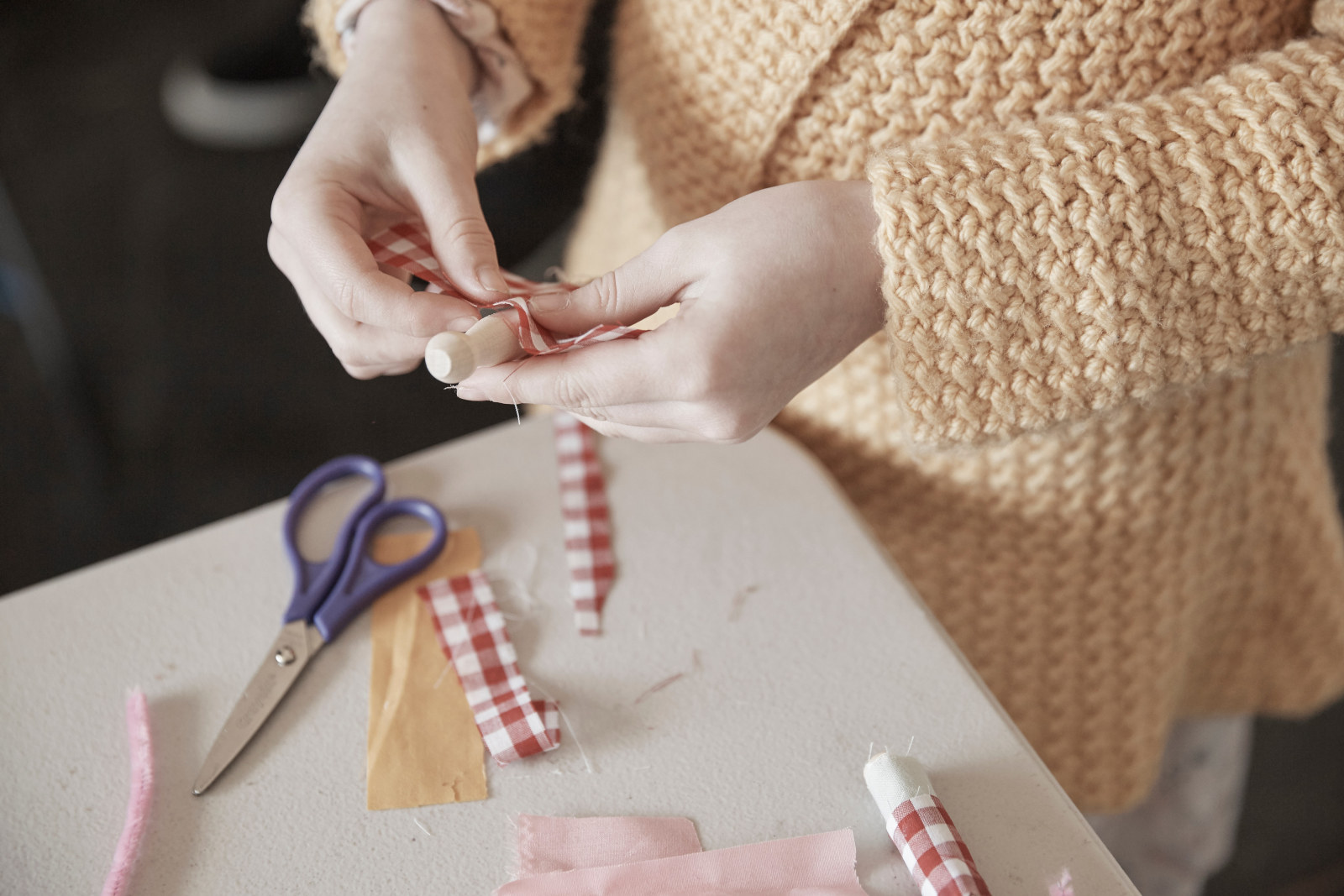 Girl making a peg doll at the Toy Festival